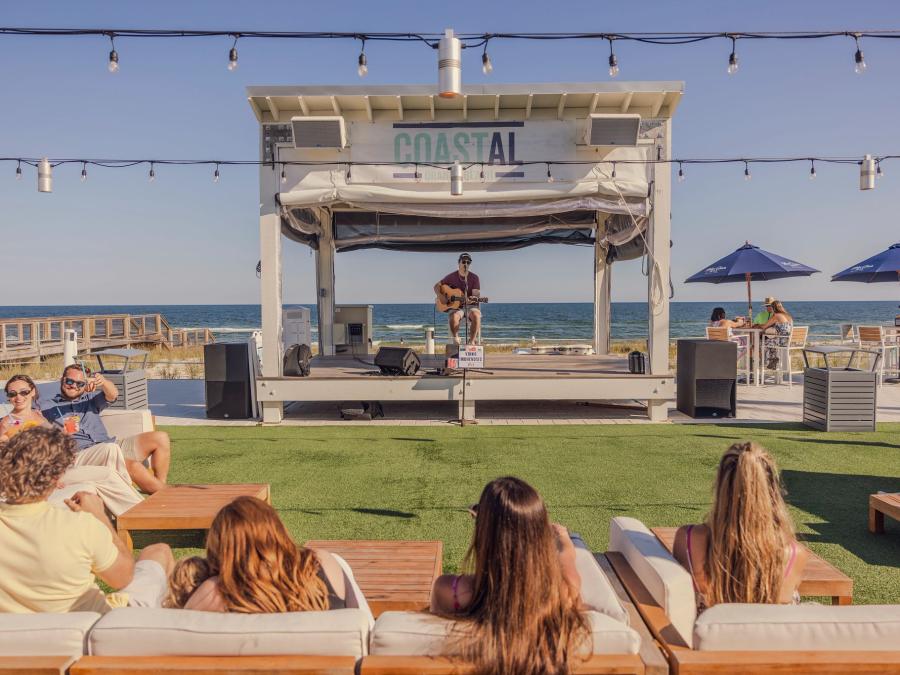 People listening to live music at Coastal beachfront restaurant in Orange Beach