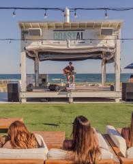 People listening to live music at Coastal beachfront restaurant in Orange Beach