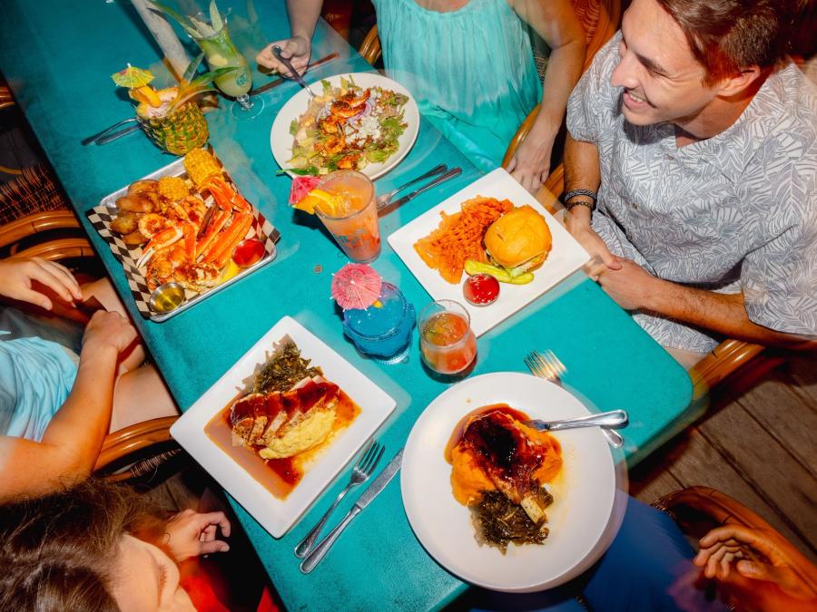 Aerial shot of people gathered around a table filled with food at GTs on the Bay
