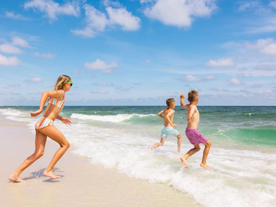 Kids running into the Gulf on the beach in Gulf Shores