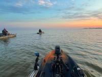 kayak fishing at sunset along Alabama's Beaches