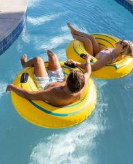 Couple floating on a lazy river at Phoenix West beachfront condo in Orange Beach