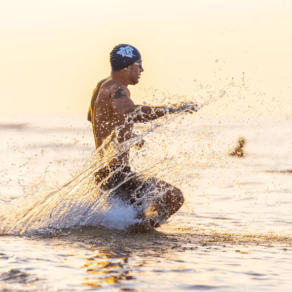 Man running a triathlon on Alabama's Beaches